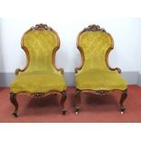 A Pair of XIX Century Walnut Framed Nursing Chairs, each with pokerwork and scroll carved