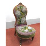 A Mid XIX Century Walnut Spoon Back Nursing Chair, the tapestry back and seat with beadwork