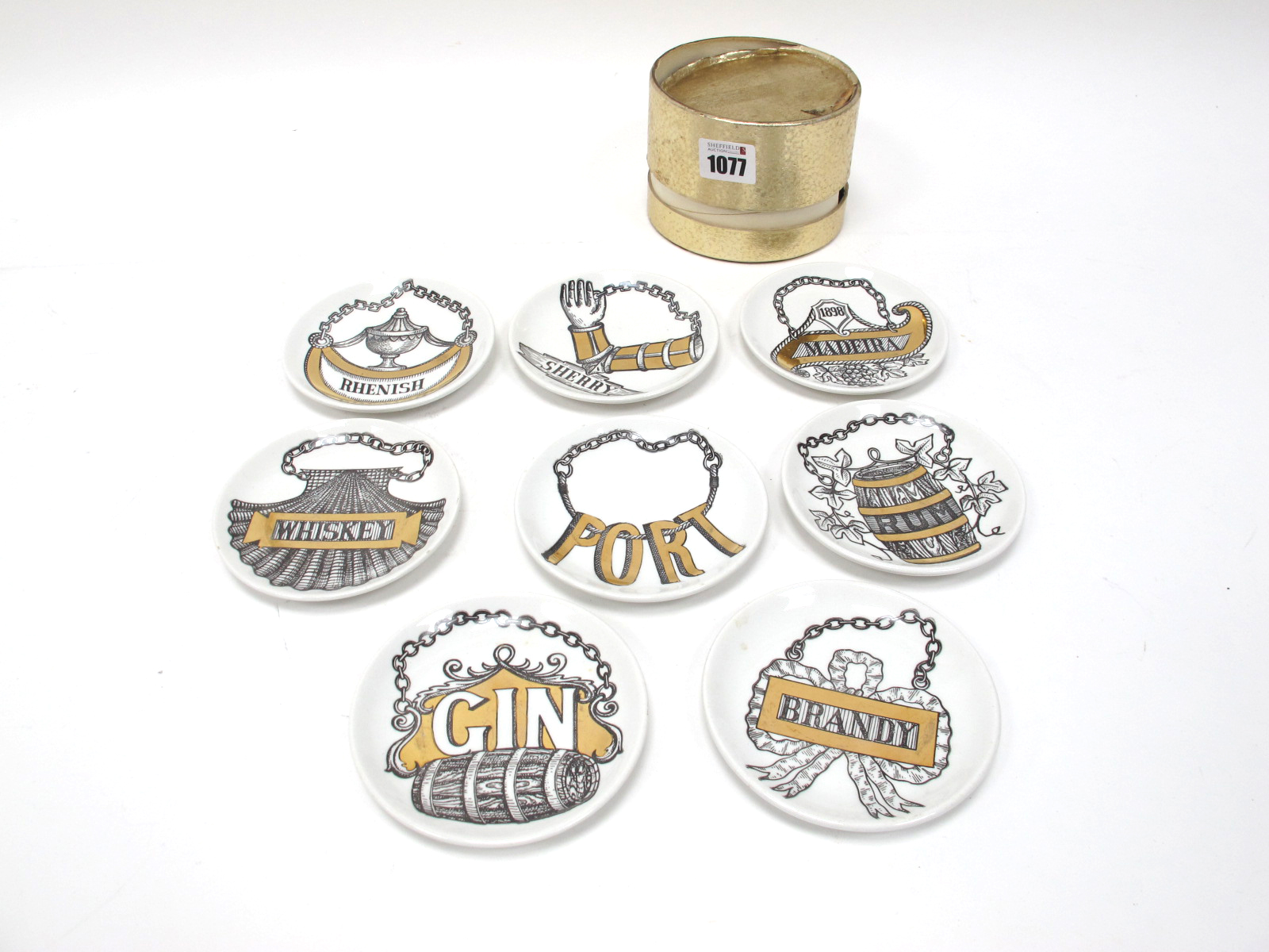 A Set of Eight Fornasetti 'Vini e Liquori' Coasters, Sherry, Madeira, Whiskey, Rhenish, Port, Rum,