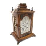 A XIX Century Oak Cased Bracket Clock, with caddy top, bronzed finials, glazed door to silvered dial