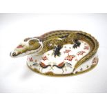 A Royal Crown Derby Paperweight 'Crocodile', gold stopper, date code for 2004, 16.5cm long.