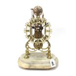 An Early XX Century Brass Skeleton Clock, the white painted chapter ring with Roman numerals of