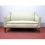 An Early XX Century Two Seater Settee, with shaped arms, on tapering legs, upholstered in a green