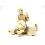 A Late XIX Century Japanese Sectional Ivory Okimono, carved as a gentleman seated cross-legged on