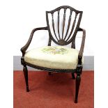 A Late XVIII Century Mahogany Hepplewhite Elbow Chair, with shield back, carved guilloche