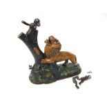 A Cold Painted Cast Iron Moneybox, modelled in the form of a lion beside a tree with two monkeys,