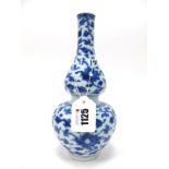 An XVIII Century Chinese Porcelain Vase, of double gourd form, painted in blue with scrolling