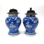 A Pair of Late XIX Century Chinese Pottery Ginger Jars, with carved hardwood covers and stands,