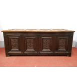 A XVII Century Joined Oak Coffer, with four lozenge panels to top over panelled base, on stile feet,