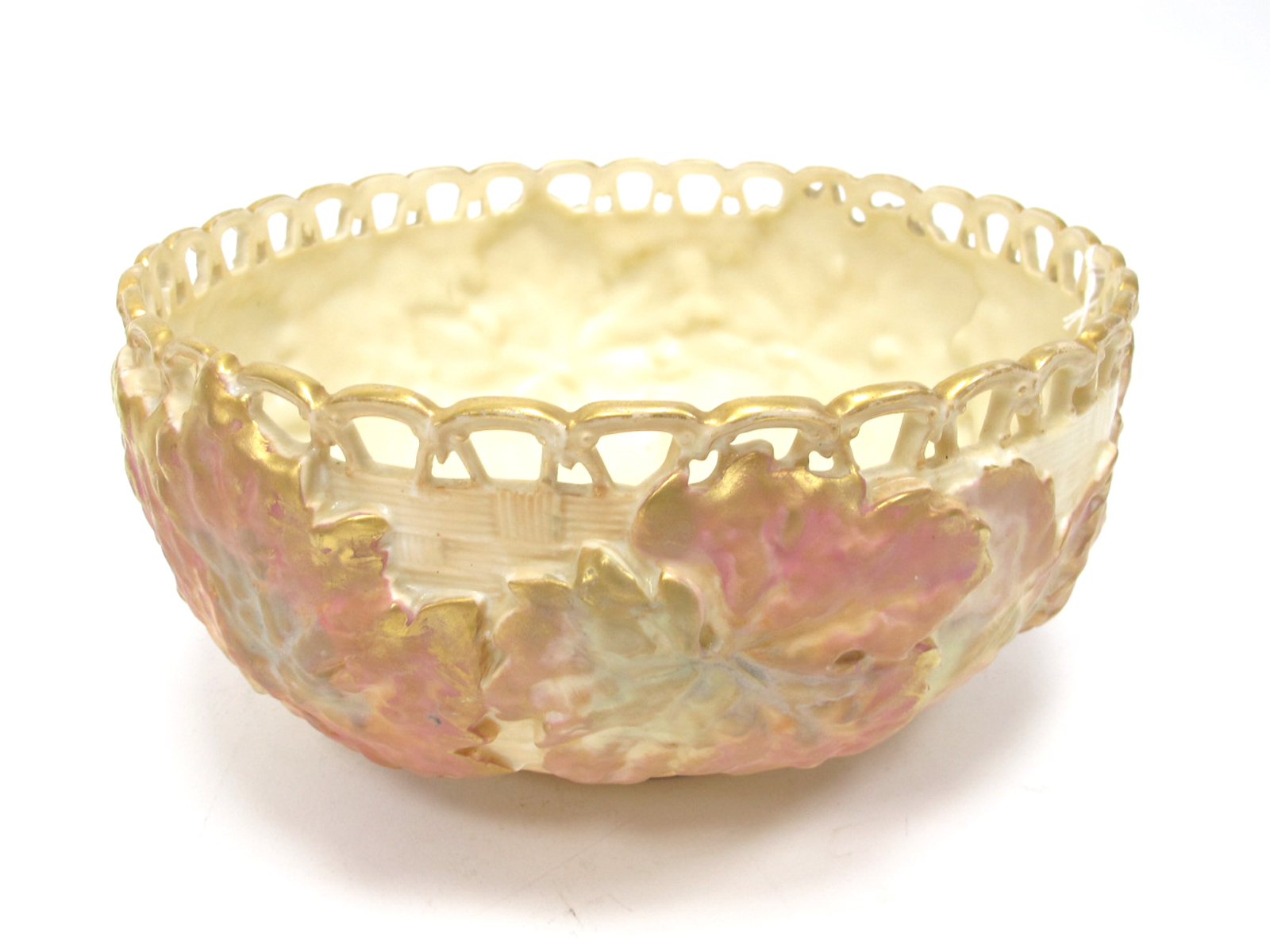 A Royal Worcester Porcelain Circular Bowl, with a pierced rim, blush ivory basket work, ground