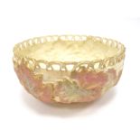 A Royal Worcester Porcelain Circular Bowl, with a pierced rim, blush ivory basket work, ground