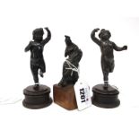 A Pair of Late XIX Century Spelter Models of Dancing Cherubs, on turned circular wooden bases,