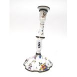 An XVIII Century Enamelled Candlestick on Copper, painted with flowers against a white ground, the