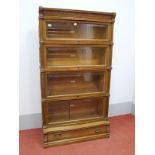 A Globe Wernicke Oak Six Tier Bookcase, with dentil cornice, column supports and panelled sides, the