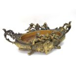 A Late XIX Century Gilt Metal Two Handled Bowl, cast in relief with cherubs and flowers, upon