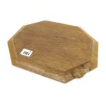 A Robert Thompson Mouseman Oak Bread Board, of rectangular form with canted corners, carved mouse