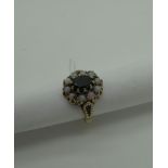 A 9ct Gold Opal And Garnet Cluster Dress Ring, oval claw set to the centre, within border of