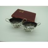 A Decorative Pair of Hallmarked Silver Salts, each of oval fluted form with twin scroll handles,