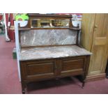 An Early XX Century Mahogany Washstand, with marble top and back, featuring mirror above, on