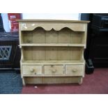 A Pine Wall Rack, with shaped apron, single shelf and three small drawers.