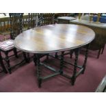 A 1920's Oak Oval Topped Gate leg Table, on barley twist supports.