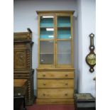 A XIX Century Pine Kitchen Cabinet, with stepped pediment, twin glazed doors, over three drawers