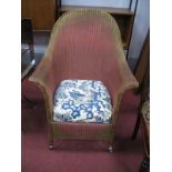 An Early XX Century Lloyd Loom Style Armchair, painted in red gilt, splayed back legs.