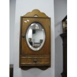 A 1920's Oak Wall Cabinet, with oval mirror and single drawer.