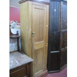 A Mahogany Cupboard, with panelled door, on a plinth base.