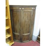 A XIX Century Mahogany Bow Fronted Corner Cupboard, with twin panelled doors, three internal