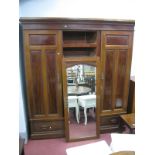 An Early XX Century Mahogany Triple Wardrobe, with stepped cornice, two hanging compartments, the
