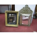 A XVII Century Style Embossed Cushion Brass Mirror, with shell and C scroll decoration, together