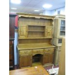 Pine Dresser with Twin Cupboards to Planked Rack, the base having three drawers and two cupboards,