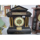 A Late XIX Century Black Slate Mantel Clock, with column supports, circular enamel base, plinth