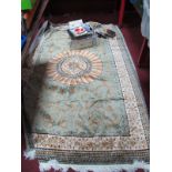 WITHDRAWN Silk Style Tasseled Rug, with symmetrical design on green ground, approximately 225 x 146