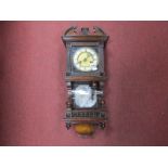 An Early XX Century Wall Clock, in walnut casing the dial featuring cross arrows trade mark,