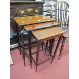 An Edwardian Nest of Tables with cross banded tops, on square turned legs.