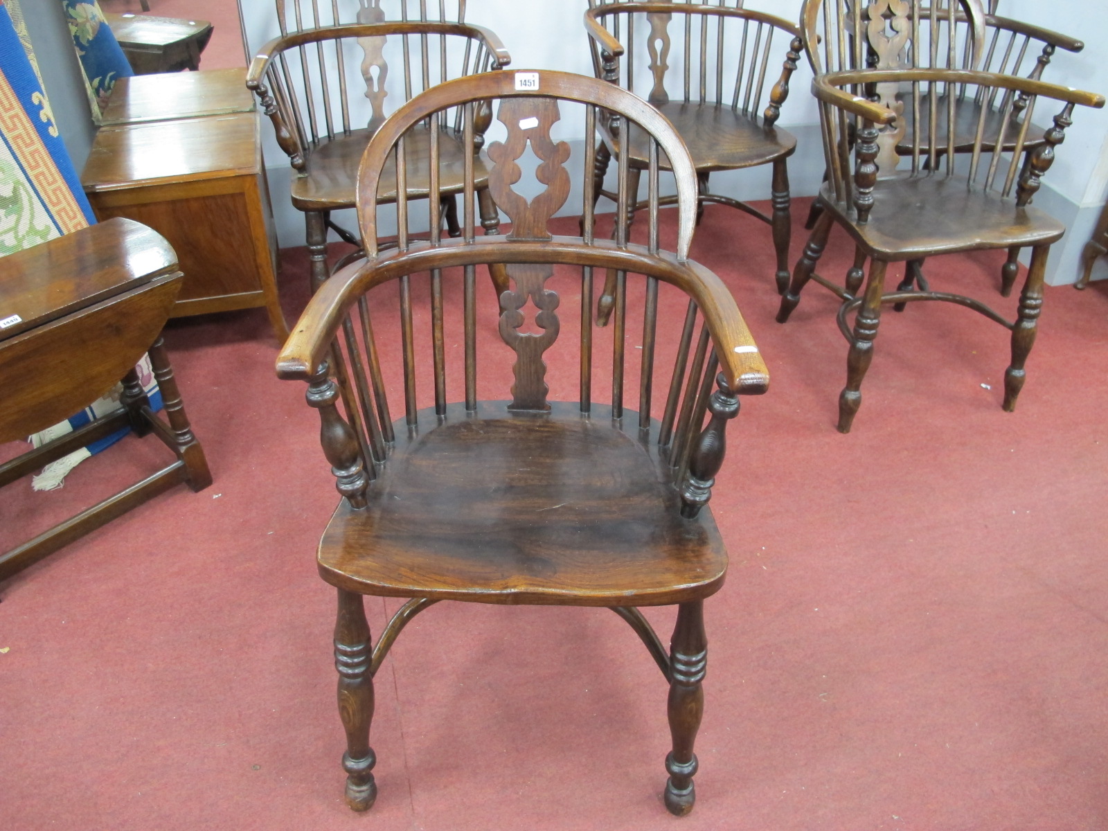 A XIX Century Ash Elm Windsor Chair, with a hooped back, pierced splat, rail supports on turned