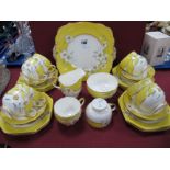 Paragon 'Narcissus' Tea Ware, of thirty six pieces on yellow ground with gilt highlights.