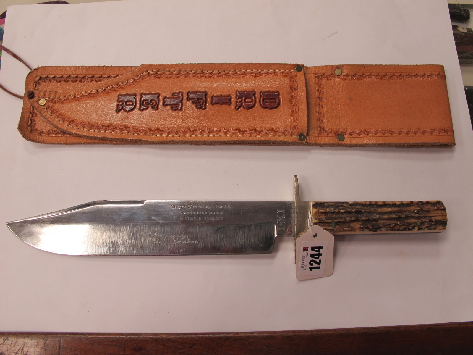 A Bowie Knife by George Wostenholm, stag handle, 25cm blade 37.5cm full length, in a leather