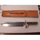 A Bowie Knife by George Wostenholm, stag handle, 25cm blade 37.5cm full length, in a leather