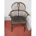 A XIX Century Ash Elm Windsor Chair, with a hooped back, pierced splat rail supports on turned legs,