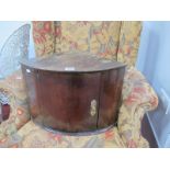 A Small XVIII Century Mahogany Bow Fronted Corner Cupboard, with brass escutcheon, 31cm high.