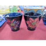 A Pair of Small Moorcroft Pottery Vases, painted in the 'Clematis' pattern on blue grounds, 7cm