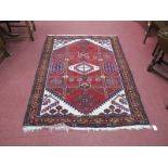 A XX Century Persian Style Wool Rug, with a central lozenge tassel ends, 152cm x 113cm.