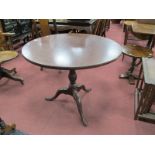 A XVIII Mahogany Pedestal Table, with a circular top, turned pedestal on cabriole legs, pad feet.