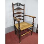 An Early XIX Century Ash Elm Ladder Back Chair, with shaped arms, rushed seat, on turned legs,