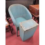A Lloyd Loom Lusty Armchair, together with a laundry basket (both with labels). (2)