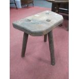 A XIX Century Elm Cutters Stool, on three legs, 45cm high.