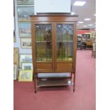 An Edwardian Mahogany Inlaid Display Cabinet, with a applied pediment, twin astragel doors, two